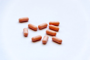 Orange pills on white background