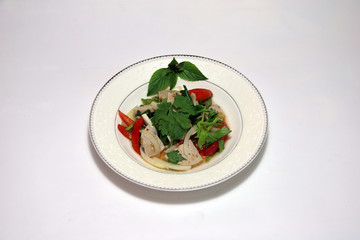 Spicy Vietnamese Pork Sausage salad in the white palette on the white background. It is Spicy food of Southeast Asian, with a sour taste.