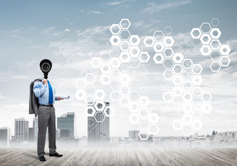 Camera headed man standing on wooden floor against modern cityscape