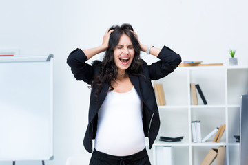 Fototapeta na wymiar pregnant businesswoman screaming