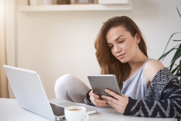 Fototapeta premium Student using tablet and sitting in study room