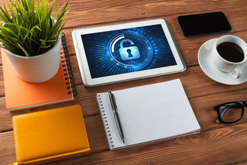 Web security and technology concept with tablet pc on wooden table