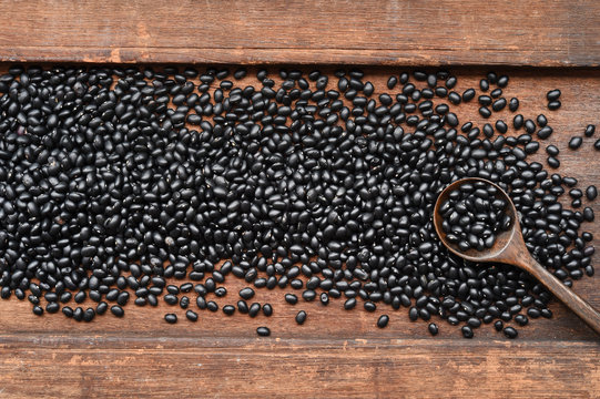 Black beans on wooden background