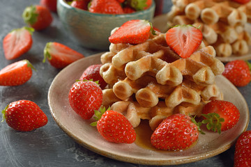 Waffles with maple syrup and strawberries