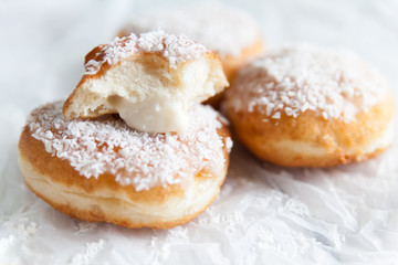 Obraz na płótnie Canvas Deep-fried doughnuts filled with coconut custard cream