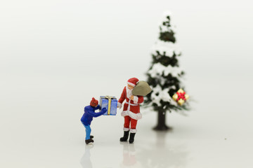 Miniature Santa Claus make gift for children on Christmas day.