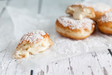 Deep-fried doughnuts filled with coconut custard cream