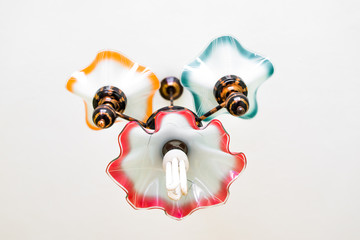 Retro chandelier with energy efficient bulb hanging under ceiling