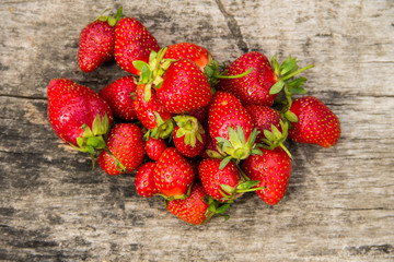 Ripe fresh strawberries on rustic wooden background. Top view