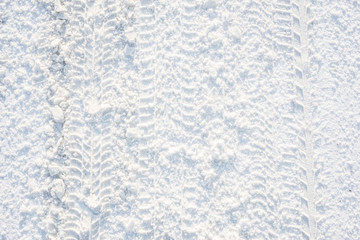 Road in winter, texture of snow and and traces of the tread