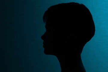 Silhouette of a girl with short hair studio portrait