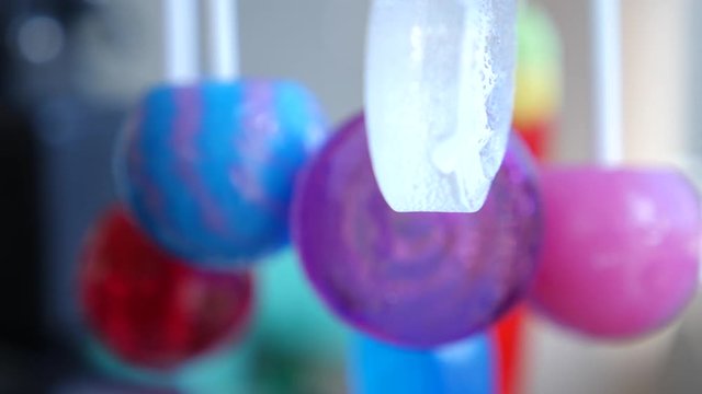 colorful lollipops hang in the air. 4k slow motion