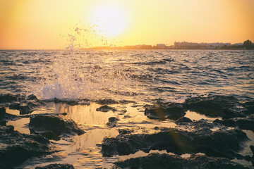 Fototapeta na wymiar Rocky coast of the sea with splashing waves