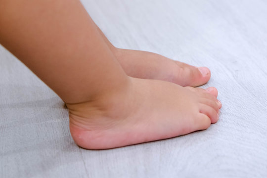 Children's bare feet. Child's bare feet the wooden floor