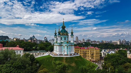 Aerial top view of Saint Andrew's church and Andreevska street from above, cityscape of Podol...