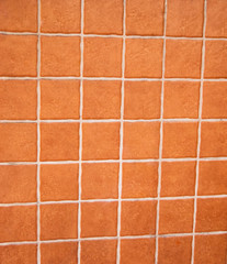 Texture of the wall lined with red ceramic stone