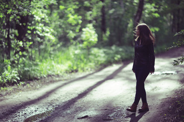 Young adult girl on a walk in the park jacket clothes