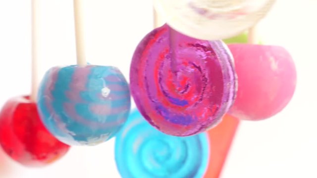 colorful lollipops hang in the air. 4k slow motion