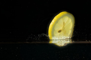 A slice of lemon dipping into water