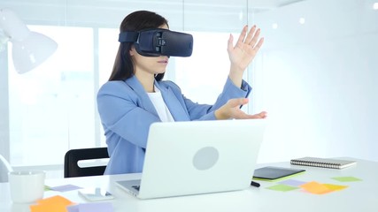 Wearing virtual reality glasses in Office. Using VR goggles headset - Powered by Adobe
