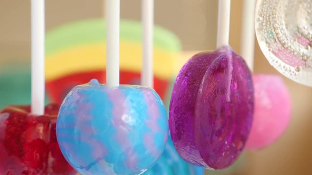 colorful lollipops hang in the air. 4k slow motion