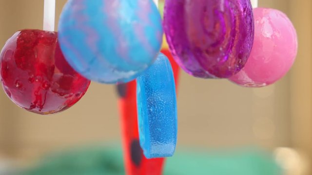 colorful lollipops hang in the air. 4k slow motion