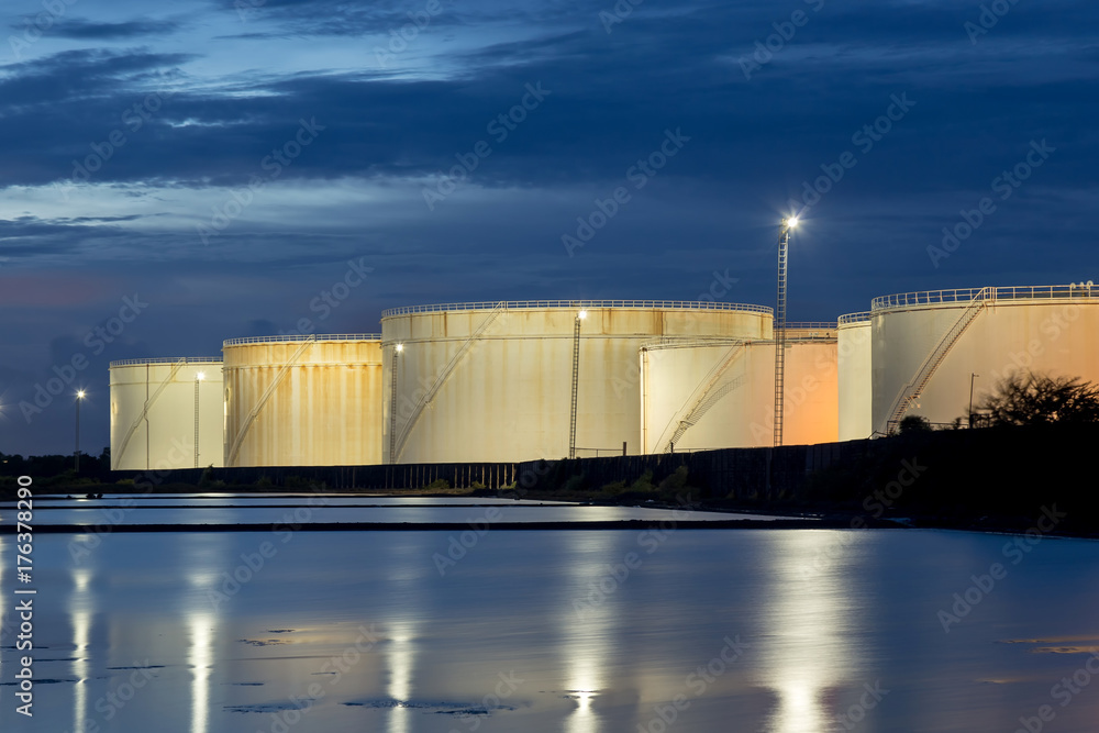 Wall mural oil storage tanks with blue sky and clouds