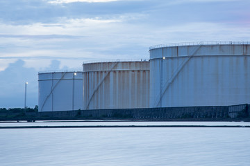 oil storage tanks with blue sky and clouds