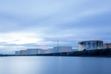 oil storage tanks with blue sky and clouds