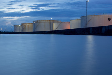 Obraz premium oil storage tanks with blue sky and clouds
