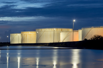 oil storage tanks with blue sky and clouds