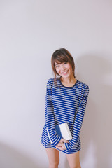  A fashion portrait of young hipster asian woman wearing stripe T-shirt