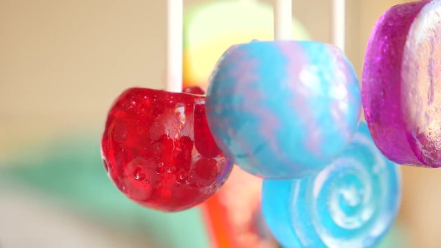 colorful lollipops hang in the air. 4k slow motion