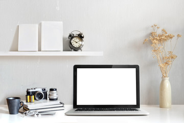 Mockup copy space blank screen laptop and office supplies on white desk. Stylish workspace concept.