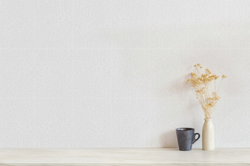 Copy space. Mock up vintage vase flowers and black coffee mug. Interior vintage style.
