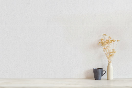 Copy space. Mock up vintage vase flowers and black coffee mug. Interior vintage style.