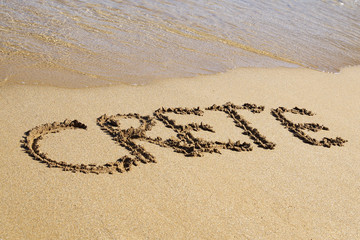 Text CRETE written in sand