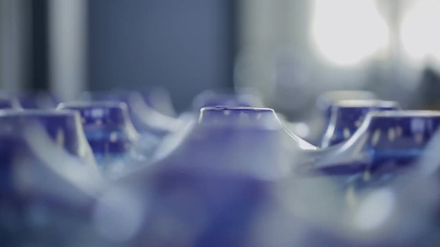 On container ready to pack bottles of water revolves around. Blue packaging in polyethylene film is ready for transportation for delivery to consumer.