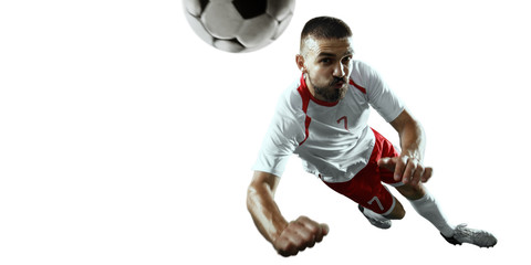 Fototapeta na wymiar Soccer player performs an action play and beats the ball. Isolated football player in unbranded sport uniform on a white background.