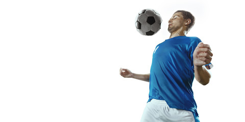 Soccer player performs an action play and beats the ball. Isolated football player in unbranded...