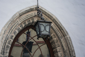 Lamp above a stone arch window