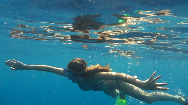 Teenage girl snorkeling, swimming in sea, super slow motion 240fps
