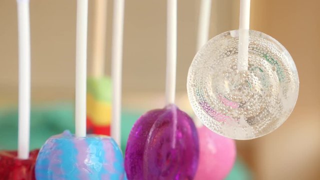 colorful lollipops hang in the air. 4k slow motion