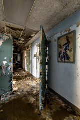 Fototapeta na wymiar Hallway with Art Work - Abandoned Hudson River State Hospital - New York