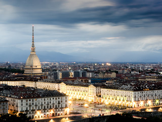 Fototapeta na wymiar Cityscape of Torino (Turin, Italy) at sunset cloudy sky
