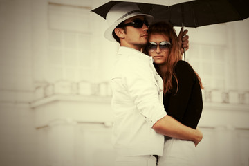 Young fashion couple in love with umbrella