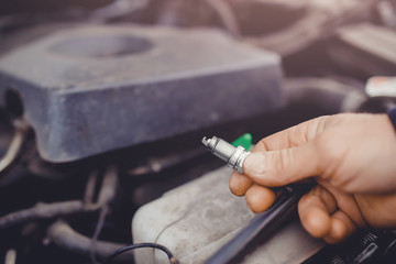 auto mechanic keeps the spark plugs in the glove. Concept car diagnostics
