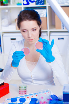 Female student with petri dishes