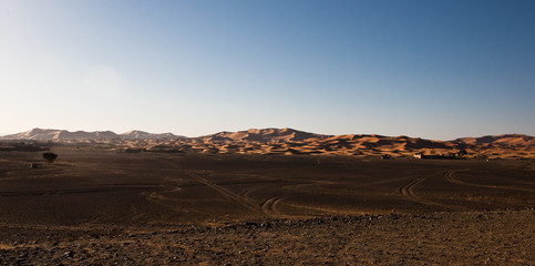 Algerian sand desert advancing along a rocky plateau