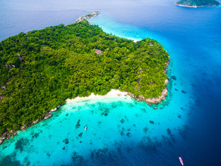 Top aerial view of isolated beautiful tropical island with white sand beach, blue clear water and...